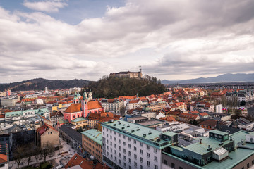 Fototapeta na wymiar Ljubljana in Slovenia on a cloudy day - River, bund, Ljubljana Castle