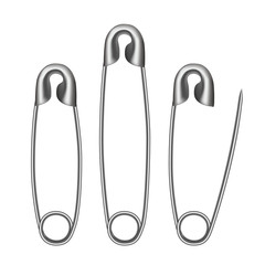 Glossy metallic safety pins on white