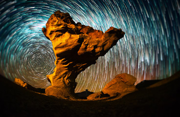 Starry sky with the star trails like comets and rock formation named Arbol de Piedra (Stone Tree) in Eduardo Avaroa Andean Fauna National Reserve of Sur Lipez Province, Bolivia. Tilt shift effect