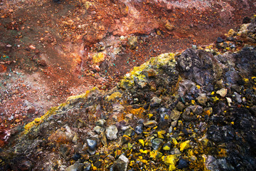 Bright multi-colored minerals on the slope of the volcano (Kamchatka, Russia) Rock formation after eruption.