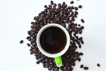 cup of coffee with beans on white background