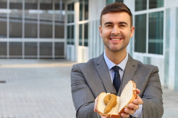 Businessman holding a disgusting poop sandwich 