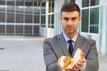 Businessman showing a poop sandwich 