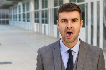 Businessman eating a cockroach at work