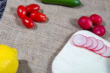 Preparation for a salad with tomatoes cucumbers, avocado and lemon.Preparation for a salad with tomatoes cucumbers, avocado and lemon.