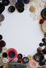 Mixed plastic buttons arranged in a circle frame with space for text