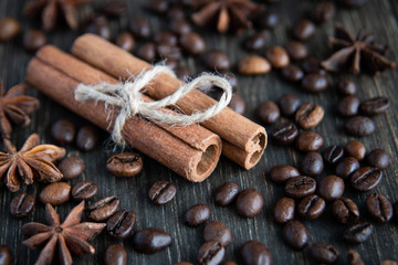 Spicy background. Warm christmas theme. Cinnamon quills tied with rope, coffee beans and star anise