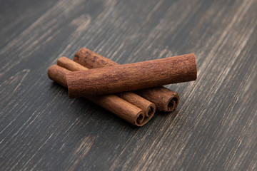 Cinnamon quills on wooden background