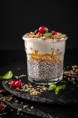 Сhia pudding or yogurt with granola, mango or peach. Healthy breakfast concept and idea. Detox and healthy superfoods.