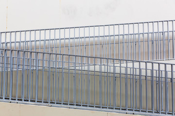 handrails lead upwards at a concrete wall
