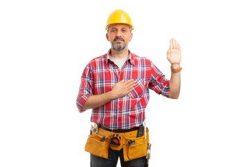 Builder swearing with palm up and hand on heart.