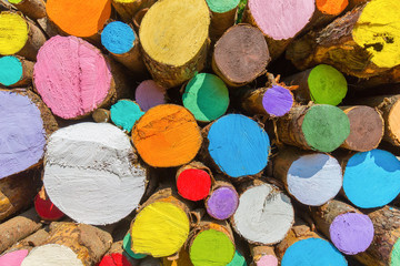 Stack of colorful painted tree trunks