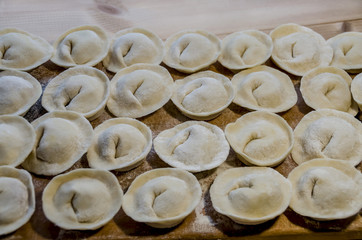 delicious homemade dumplings with meat on a wooden background