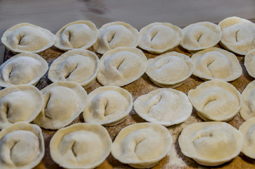 delicious homemade dumplings with meat on a wooden background