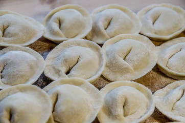 delicious homemade dumplings with meat on a wooden background