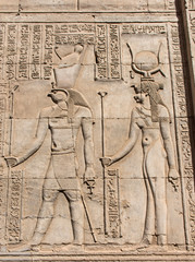 Hieroglyphic carvings on an ancient egyptian temple wall