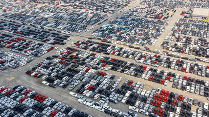 Cars export terminal in export and import business and logistics. Shipping cargo to harbor. Water...