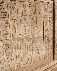 Hieroglyphic carvings on an ancient egyptian temple wall