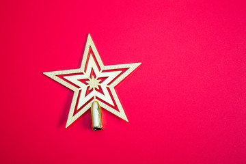 Golden Christmas star on red background