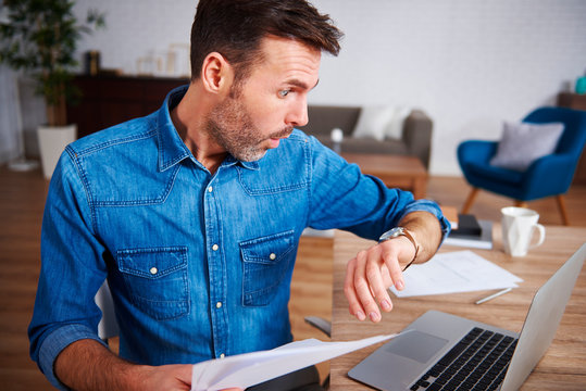 Worried man checking the time