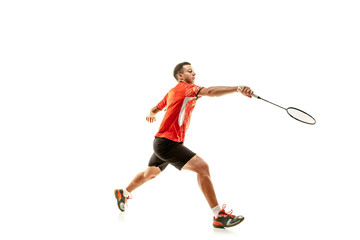 Fototapeta na wymiar Young man playing badminton over white studio background. Fit male athlete isolated on white. badminton player in action, motion, movement. attack and defense concept