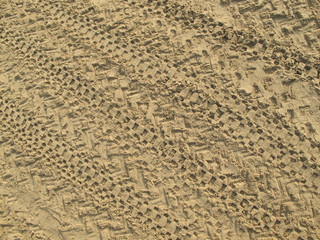 Sand That Has Been Run Over By Motorbikes, Traces Of Motorcycle Tires On Brown Sand