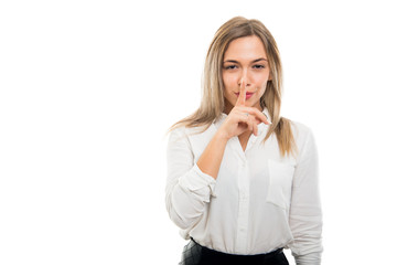 Portrait of business woman making silence gesture