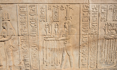 Hieroglyphic carvings on an ancient egyptian temple wall