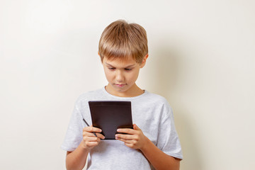 Kid drawing with graphic tablet and stylus pen