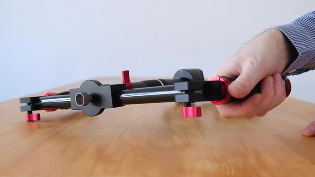 Unidentified man reviews just bought stabilizer for camera