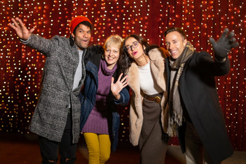 Group of friends posing for photo at Christmas market.