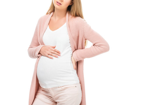 cropped view of tired pregnant woman with right hand on belly isolated on white