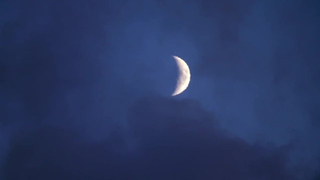 The moon is covered with thick smoke in the night sky. Clouds in the night.