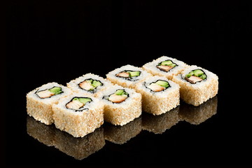 Traditional japanese sushi roll with sea eel on a glossy black background