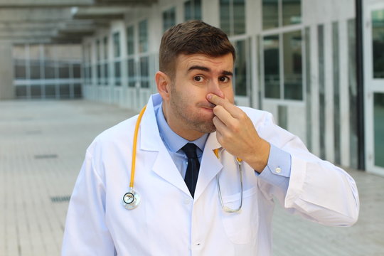 Doctor suffering an unpleasant smell 