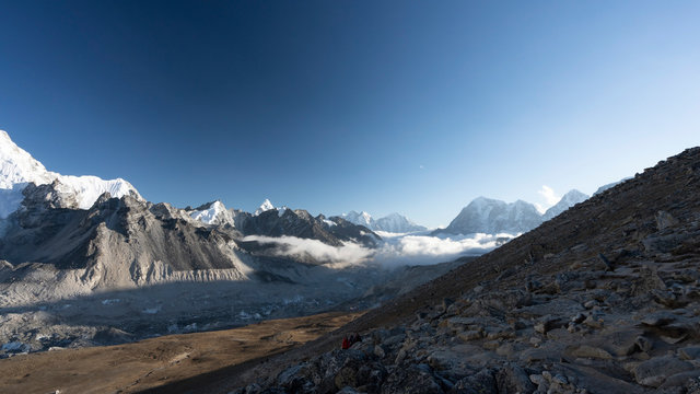 Evening clouds are rolling in over Khumbu Valley. At nightfall clouds typically roll in upwards over Khumbu Valley and Glacier, seen from the peak of Kala Patthar.