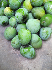 Pile of Mangga Apel Green Mangoes, on Concrete Background