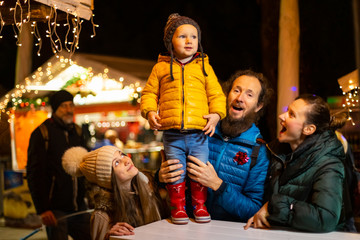 Family enjoying traditional Christmas market in Zagreb, Croatia.
