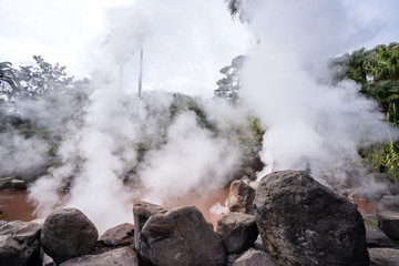 Red hot spring near UMI JIGOKU (Sea Hell) pond in autumn, which is one of the famous natural hot springs viewpoint, the japanese in picture means 