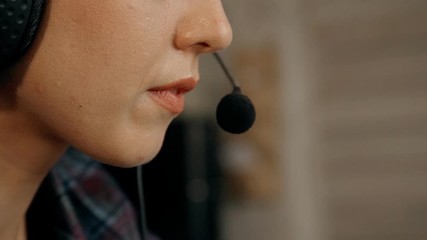 Operator of helpline is talking using microphone.