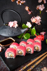 Obraz na płótnie Canvas Tuna Sushi Roll with eel, cream cheese Philadelphia and avocado Sushi menu. Japanese food. 