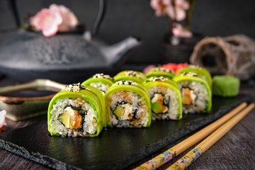 Vegetarian sushi rolls avocado with cream Philadelphia cheese, sesame, unagi sauce. Sushi menu. Japanese food. 