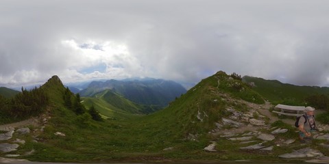 Middle age man hiking in Switzerland mountains at summer, 360 panorama
