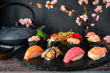 Nigiri with Tuna, Salmon, Eel and Shrimp. Gunkan sushi set.  Dish decorated with a sprig of cherry...