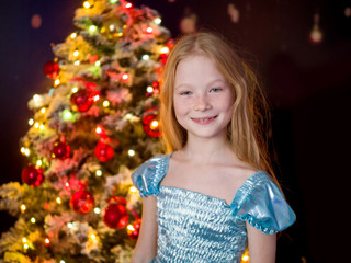 Beautiful baby and Christmas tree in the interior