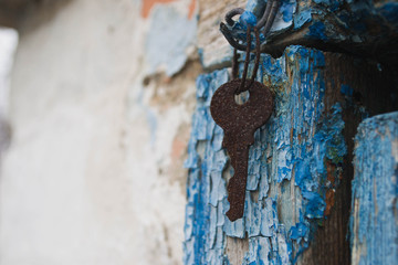 Fototapeta na wymiar Old rusty key hanging on a nail