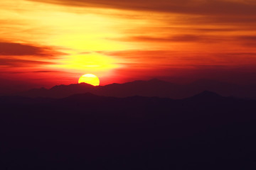 Sunrise or sunset at the sea behind the mountain