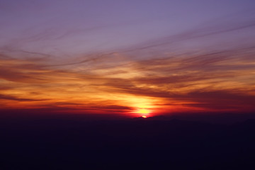 Fototapeta na wymiar Sunrise or sunset at the sea behind the mountain