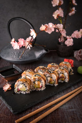 Unagi roll with smoked eel, avocado, cream with Philadelphia cheese, tobiko caviar. Sushi menu. Japanese food. 