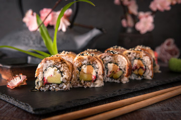 Unagi roll with smoked eel, avocado, cream with Philadelphia cheese, tobiko caviar. Sushi menu. Japanese food. 